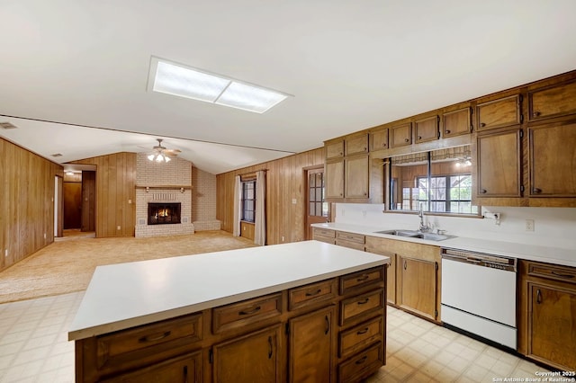 1212 County Road 337, La Vernia, TX 78121 - kitchen featuring white dishwasher, a sink, light floors, vaulted ceiling, and ceiling fan