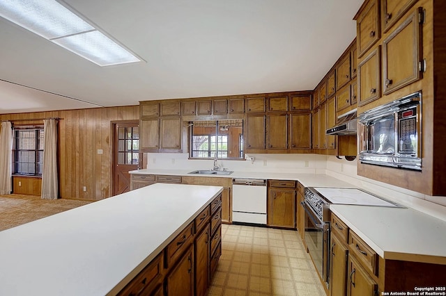 1212 County Road 337, La Vernia, TX 78121 - kitchen with dishwasher, range with electric stovetop, black microwave, light floors, and light countertops