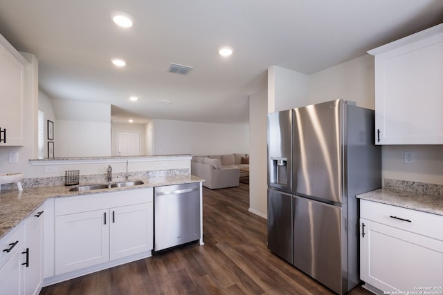 13735 Prospector Post, San Antonio, TX 78253 - kitchen with stainless steel appliances, a sink, a peninsula, dark wood-style floors, and white cabinets