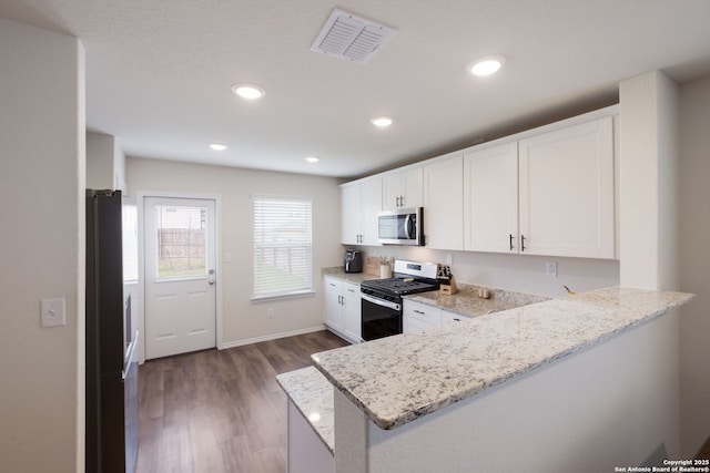 13735 Prospector Post, San Antonio, TX 78253 - kitchen featuring appliances with stainless steel finishes, a peninsula, white cabinets, light stone counters, and recessed lighting
