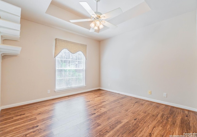 5535 Circle Oak Dr, Bulverde, TX 78163 - spare room with wood finished floors, a raised ceiling, ceiling fan, and baseboards