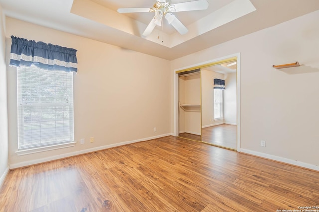 5535 Circle Oak Dr, Bulverde, TX 78163 - spare room featuring a raised ceiling, wood finished floors, a ceiling fan, and baseboards