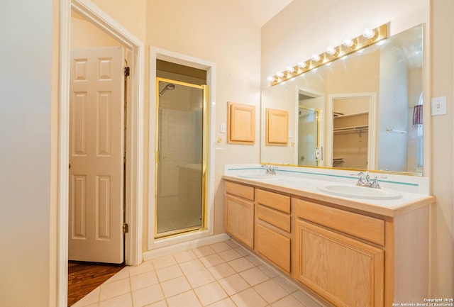 5535 Circle Oak Dr, Bulverde, TX 78163 - bathroom featuring double vanity, a stall shower, a walk in closet, and tile patterned floors