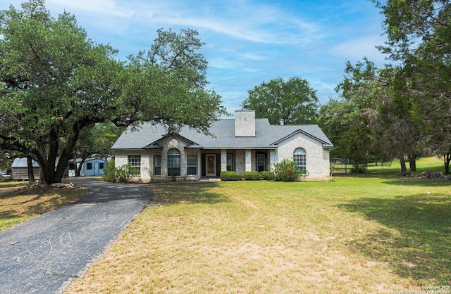 5535 Circle Oak Dr, Bulverde, TX 78163 - view of front of property with a chimney, a front yard, and driveway
