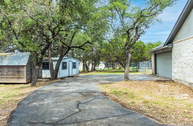 5535 Circle Oak Dr, Bulverde, TX 78163 - view of yard with asphalt driveway and an attached garage