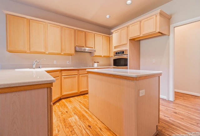 5535 Circle Oak Dr, Bulverde, TX 78163 - kitchen featuring light brown cabinetry, stainless steel oven, under cabinet range hood, light wood-style floors, and recessed lighting