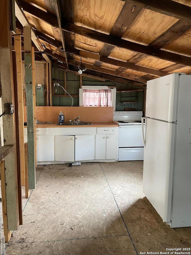 837 Denver, New Braunfels, TX 78130 - kitchen with white appliances, vaulted ceiling, white cabinetry, and a sink