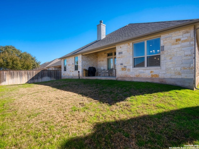 243 Bamberger, New Braunfels, TX 78132 - rear view of house with stone siding, a chimney, and a patio area
