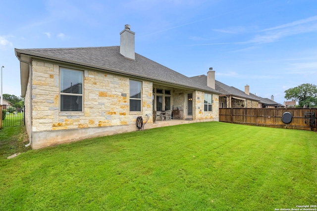 243 Bamberger, New Braunfels, TX 78132 - back of property with stone siding, a patio, a chimney, and roof with shingles