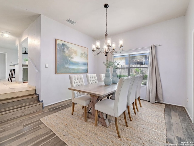 19914 Encino Moss, San Antonio, TX 78259 - dining room featuring wood finished floors, a chandelier, and stairs