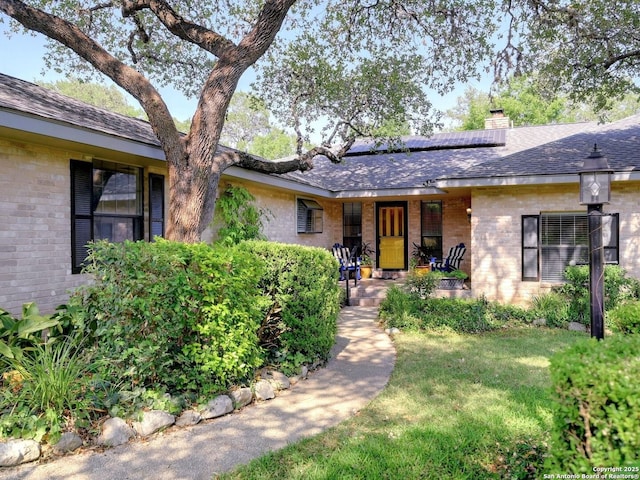 19914 Encino Moss, San Antonio, TX 78259 - single story home featuring brick siding, roof mounted solar panels, a porch, and roof with shingles