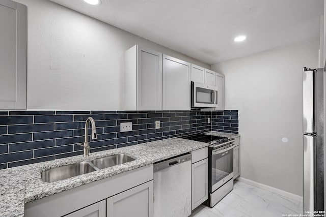 7311 Lansbury Dr, San Antonio, TX 78250 - kitchen with stainless steel appliances, a sink, light marble finish floors, light stone counters, and recessed lighting