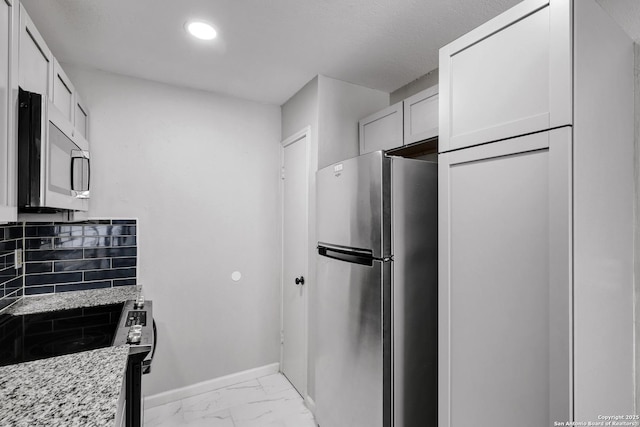 7311 Lansbury Dr, San Antonio, TX 78250 - kitchen with stainless steel appliances, baseboards, tasteful backsplash, recessed lighting, and light stone countertops