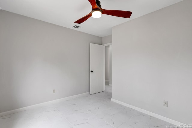 7311 Lansbury Dr, San Antonio, TX 78250 - spare room featuring light marble finish flooring, a ceiling fan, and baseboards