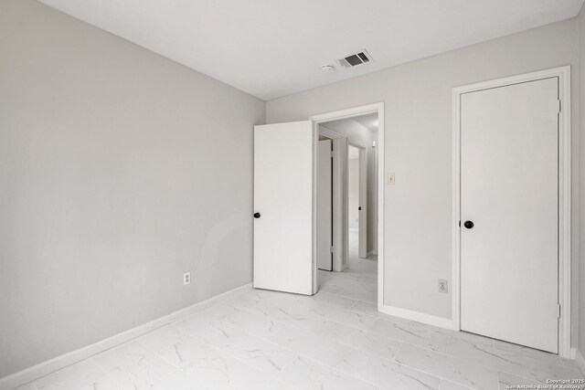 7311 Lansbury Dr, San Antonio, TX 78250 - unfurnished bedroom featuring light marble finish flooring and baseboards
