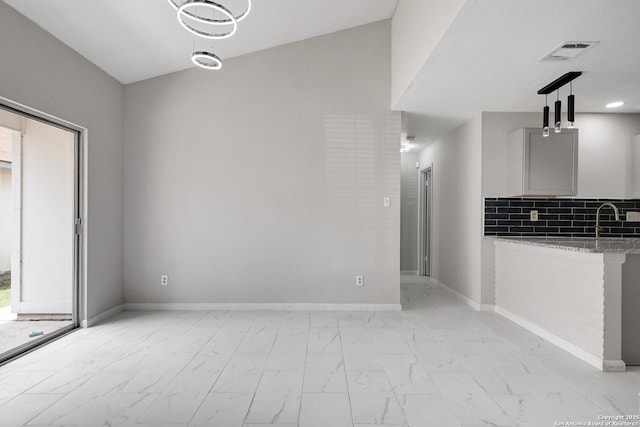 7311 Lansbury Dr, San Antonio, TX 78250 - unfurnished dining area with light marble finish floors, a sink, and baseboards