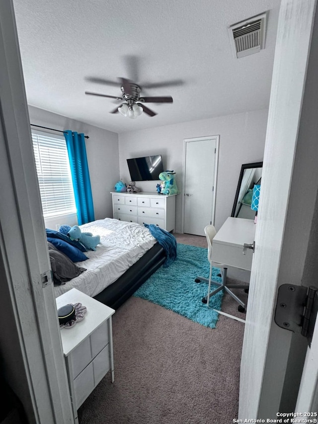 510 Tres Caminos, San Antonio, TX 78245 - carpeted bedroom with a textured ceiling and ceiling fan
