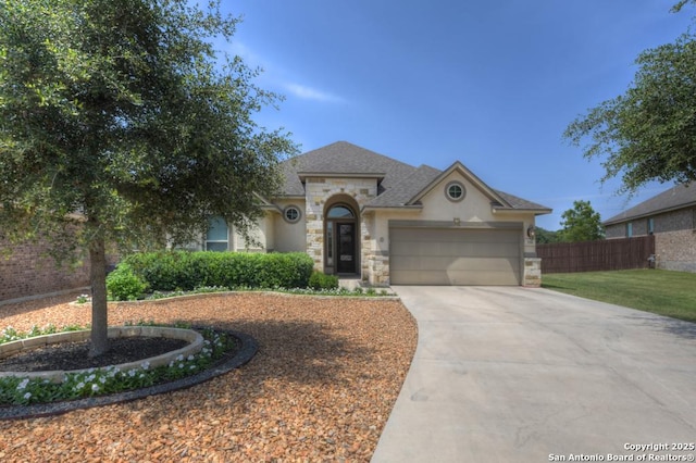 350 Wauford, New Braunfels, TX 78132 - view of front of property with stone siding, an attached garage, concrete driveway, stucco siding, and roof with shingles