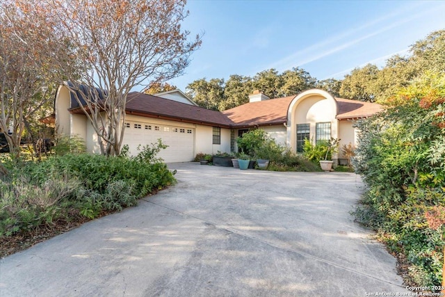 4415 Shavano Way, San Antonio, TX 78249 - single story home featuring stucco siding, driveway, a garage, and a chimney
