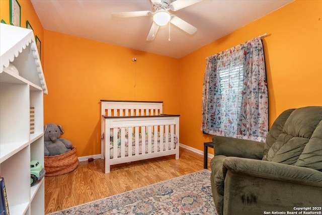 4415 Shavano Way, San Antonio, TX 78249 - bedroom with wood finished floors, baseboards, and a ceiling fan