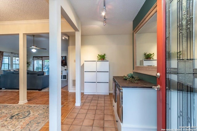4415 Shavano Way, San Antonio, TX 78249 - kitchen featuring a textured ceiling, dark countertops, ceiling fan, baseboards, and ornamental molding