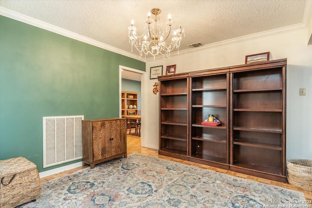 4415 Shavano Way, San Antonio, TX 78249 - unfurnished room featuring a chandelier, a textured ceiling, crown molding, and wood finished floors