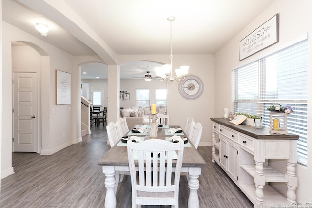 927 Lambshead Draw, San Antonio, TX 78245 - dining area featuring a chandelier, baseboards, wood finished floors, and arched walkways