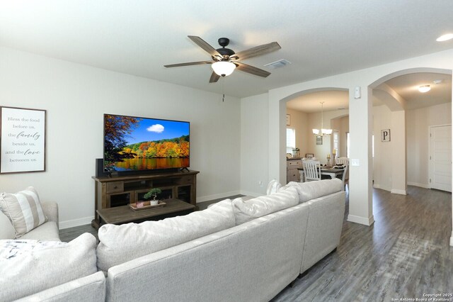 927 Lambshead Draw, San Antonio, TX 78245 - living area with arched walkways, a chandelier, a ceiling fan, wood finished floors, and baseboards