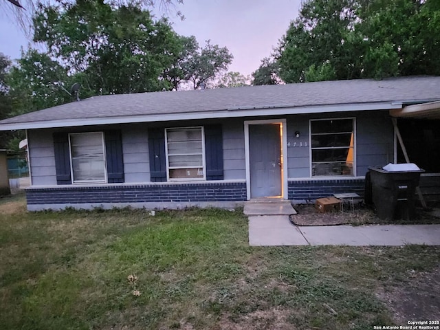 4731 Castle Queen, San Antonio, TX 78218 - view of front of house with brick siding, roof with shingles, and a lawn