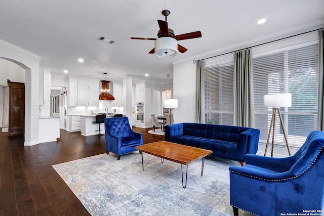 11 Gemsbuck Rise, San Antonio, TX 78258 - living area with ceiling fan, recessed lighting, dark wood-style flooring, crown molding, and arched walkways