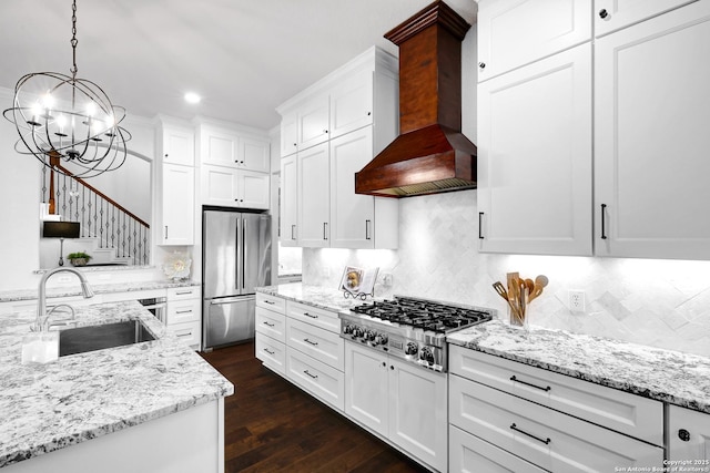 11 Gemsbuck Rise, San Antonio, TX 78258 - kitchen with appliances with stainless steel finishes, a sink, custom exhaust hood, a chandelier, and white cabinets