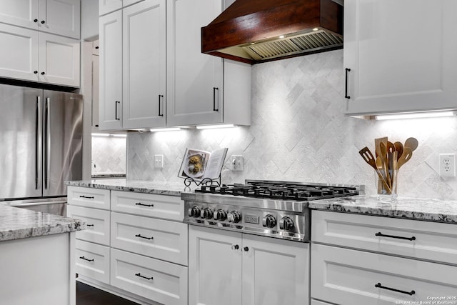 11 Gemsbuck Rise, San Antonio, TX 78258 - kitchen with stainless steel appliances, custom exhaust hood, white cabinetry, and tasteful backsplash