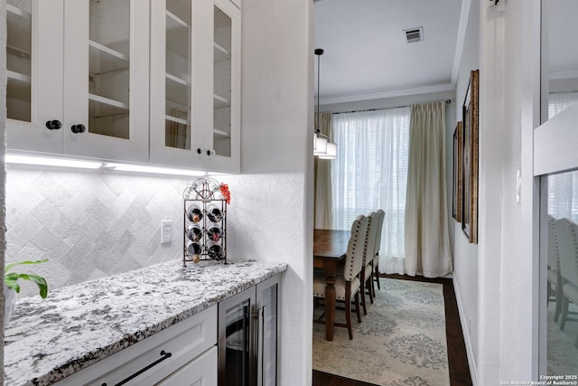 11 Gemsbuck Rise, San Antonio, TX 78258 - indoor dry bar with wine cooler, tasteful backsplash, and crown molding