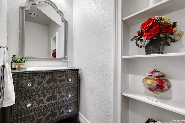 11 Gemsbuck Rise, San Antonio, TX 78258 - bathroom with a textured wall and vanity
