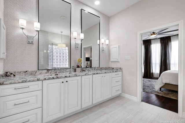 11 Gemsbuck Rise, San Antonio, TX 78258 - bathroom with double vanity, a ceiling fan, baseboards, and ensuite bath