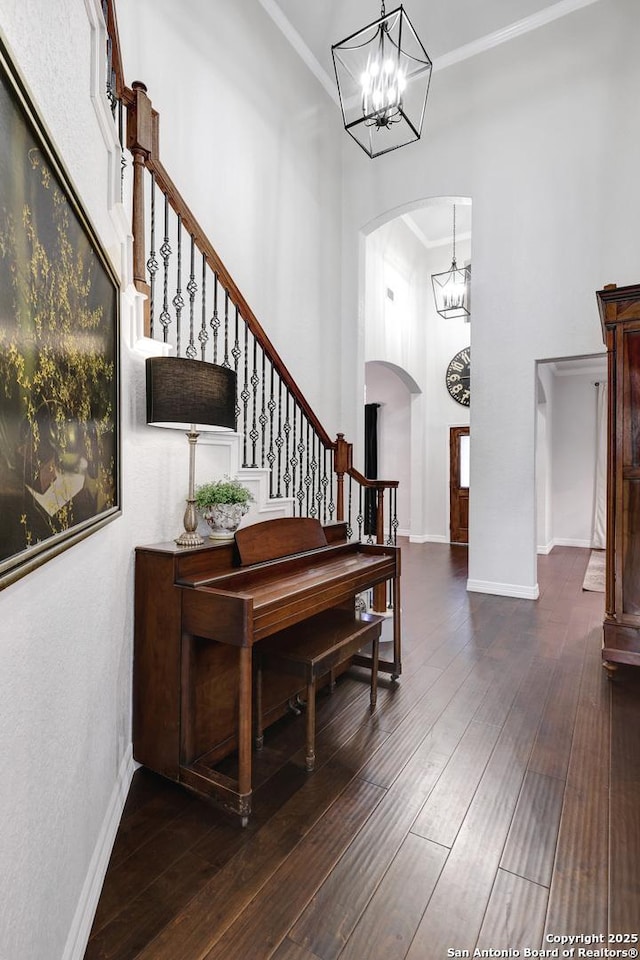 11 Gemsbuck Rise, San Antonio, TX 78258 - foyer entrance with arched walkways, a high ceiling, a chandelier, stairs, and hardwood / wood-style flooring