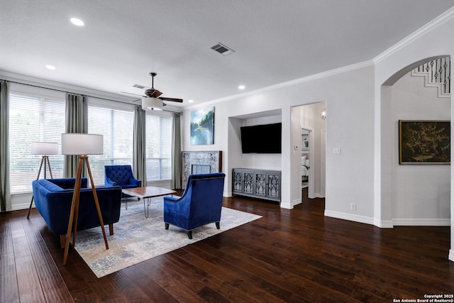 11 Gemsbuck Rise, San Antonio, TX 78258 - living room featuring crown molding, a ceiling fan, wood finished floors, baseboards, and arched walkways