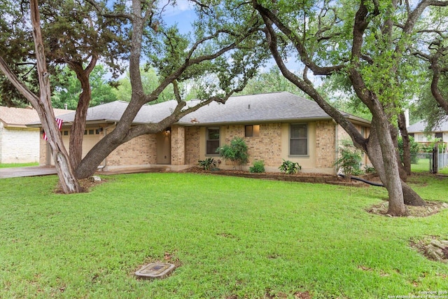 305 Rockmoor Dr, Georgetown, TX 78628 - single story home featuring concrete driveway, a garage, brick siding, and roof with shingles