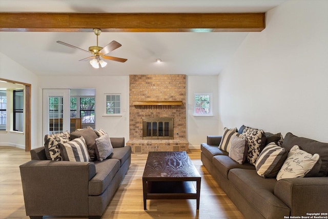 305 Rockmoor Dr, Georgetown, TX 78628 - living area featuring light wood-type flooring, ceiling fan, a brick fireplace, and baseboards