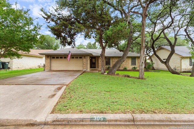 305 Rockmoor Dr, Georgetown, TX 78628 - ranch-style home with an attached garage, driveway, a front yard, and brick siding