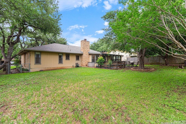 305 Rockmoor Dr, Georgetown, TX 78628 - back of house with a chimney and a sunroom