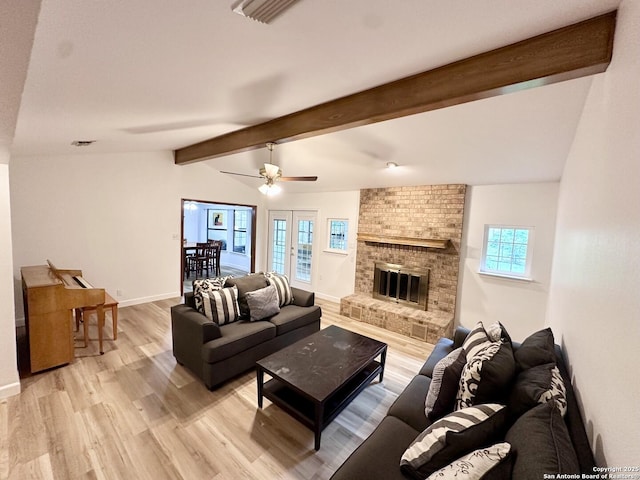 305 Rockmoor Dr, Georgetown, TX 78628 - living area with light wood-type flooring, a brick fireplace, baseboards, and ceiling fan
