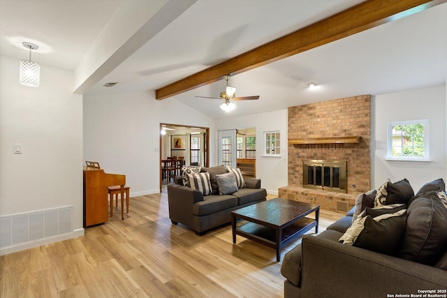305 Rockmoor Dr, Georgetown, TX 78628 - living room with light wood-style floors, a ceiling fan, baseboards, and a fireplace