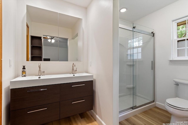 305 Rockmoor Dr, Georgetown, TX 78628 - full bath with wood finished floors, toilet, a stall shower, and double vanity