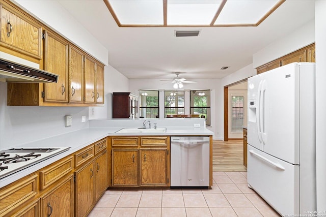 305 Rockmoor Dr, Georgetown, TX 78628 - kitchen featuring white appliances, a sink, a peninsula, and brown cabinetry