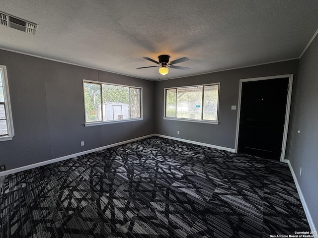 19518 Florence, Lytle, TX 78052 - carpeted empty room featuring a textured ceiling, ceiling fan, baseboards, and ornamental molding