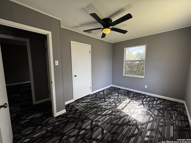 19518 Florence, Lytle, TX 78052 - unfurnished bedroom featuring dark colored carpet, crown molding, baseboards, and ceiling fan