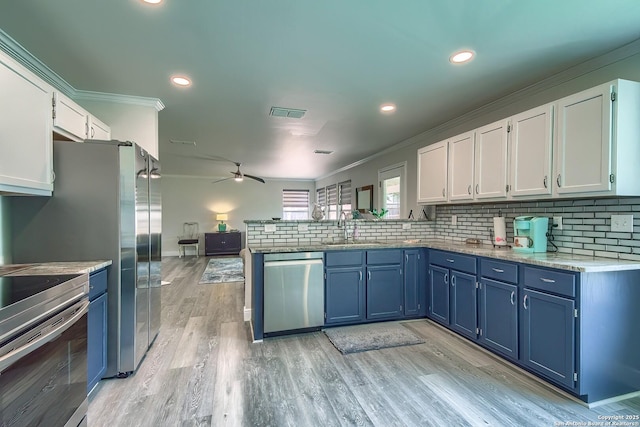 3512 Mcalister, Schertz, TX 78154 - kitchen featuring appliances with stainless steel finishes, crown molding, blue cabinets, a ceiling fan, and a sink