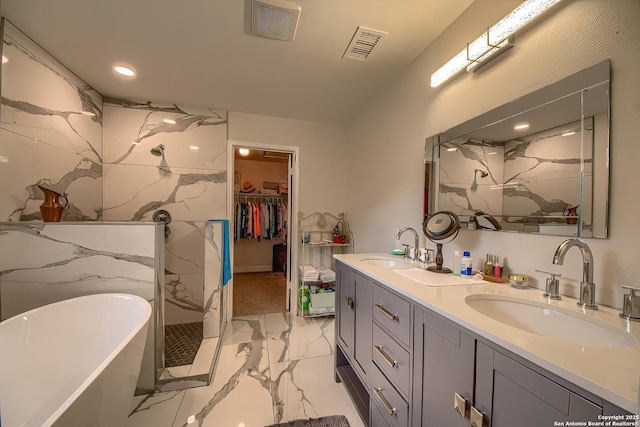 3512 Mcalister, Schertz, TX 78154 - bathroom featuring marble look tiles, double vanity, a freestanding bath, a marble finish shower, and a spacious closet
