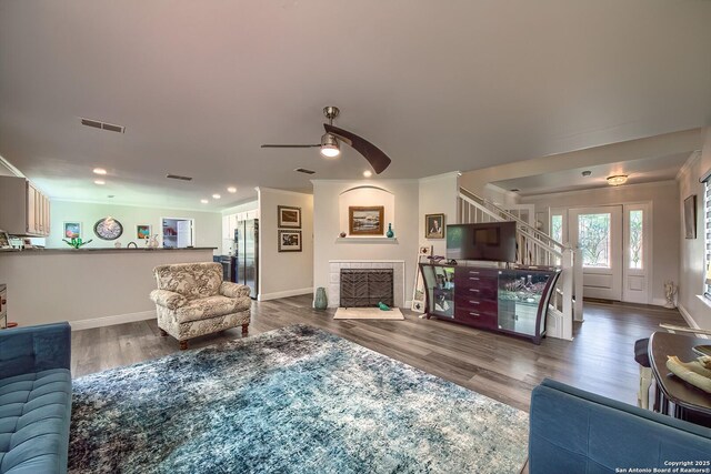 3512 Mcalister, Schertz, TX 78154 - living room with baseboards, crown molding, a ceiling fan, wood finished floors, and stairs